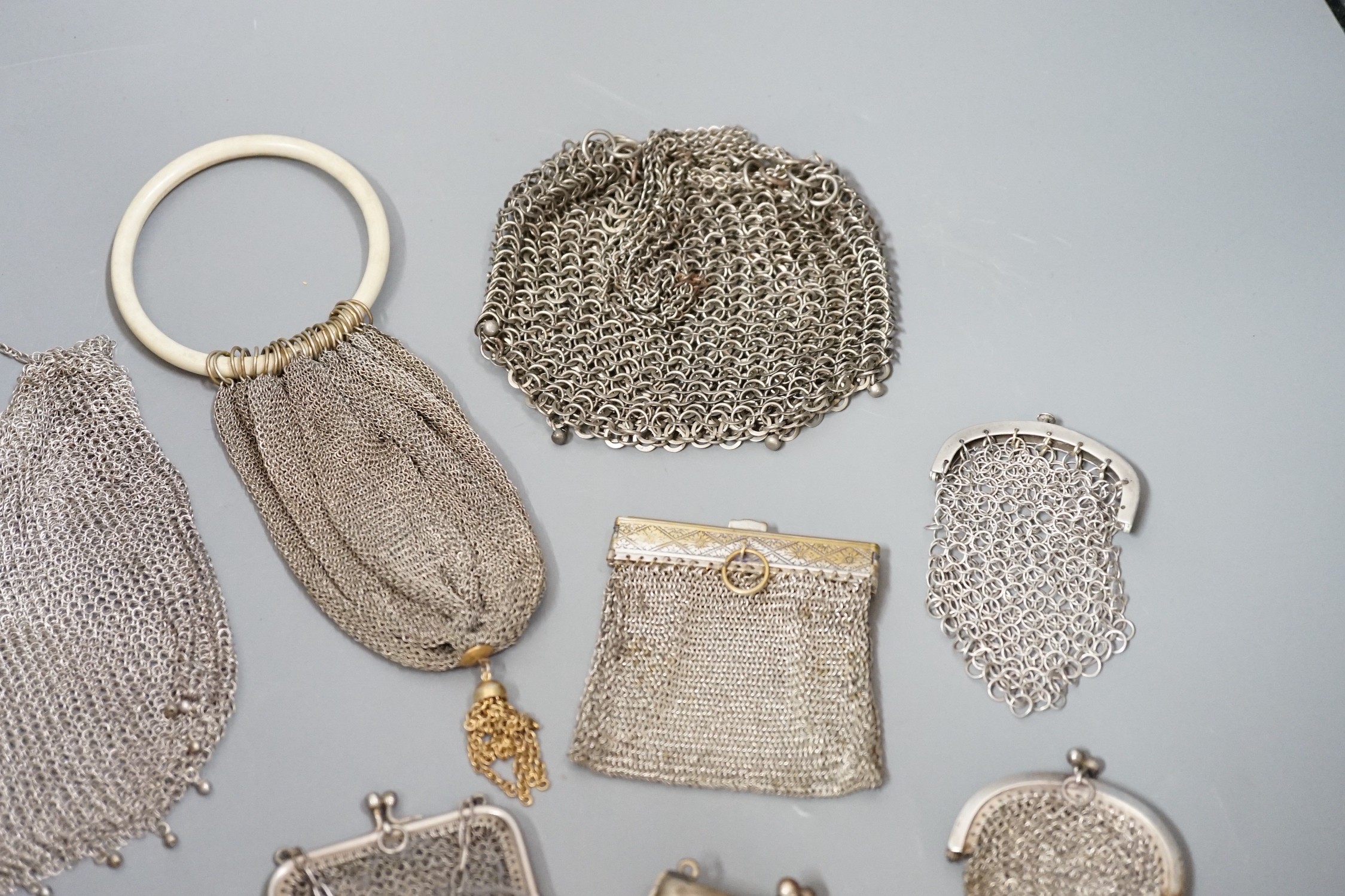 A stamped silver purse, together with eighteen metal chain mail purses and evening bags of various size, thickness and design